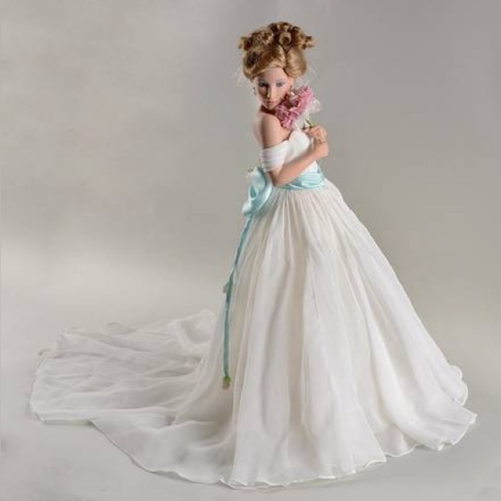 Elegant White and Blue Doll with Floral Accent